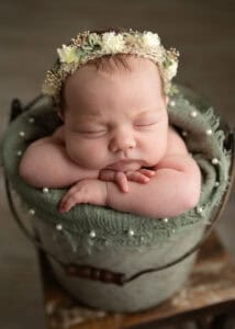 Toledo Newborn Photographer baby in a bucket with hand under chin